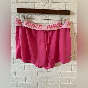 Pink Nike athletic shorts. Durable waste and and breathable material.